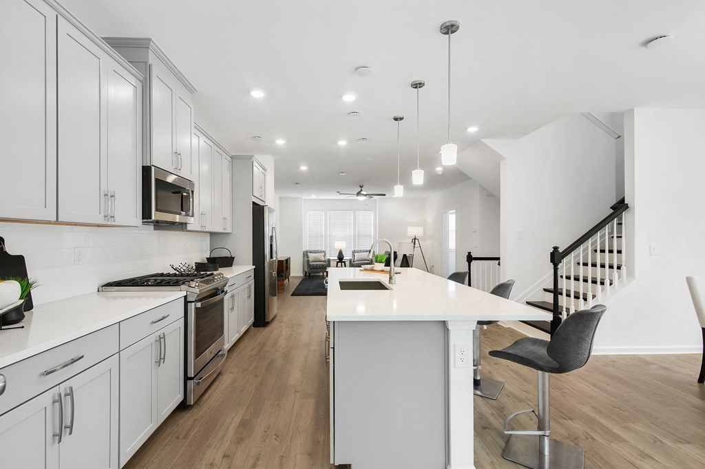 a large kitchen with white cabinets and a white counter top