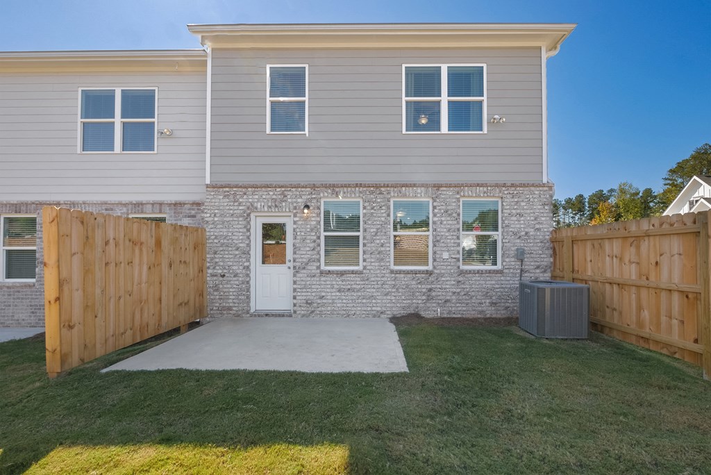 Spacious backyard with privacy fence and patio area