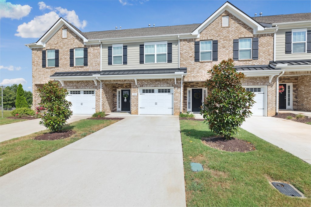 A large house with a driveway in front.