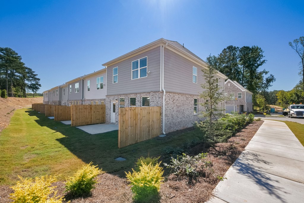 Side view of modern townhomes with landscaped walkway