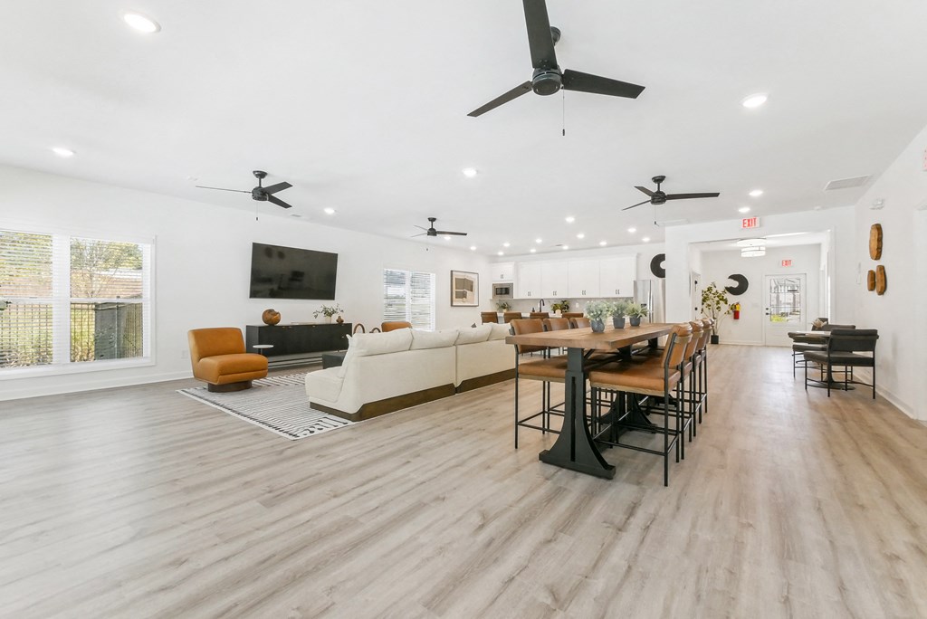 Bright open-concept clubhouse with modern ceiling fans