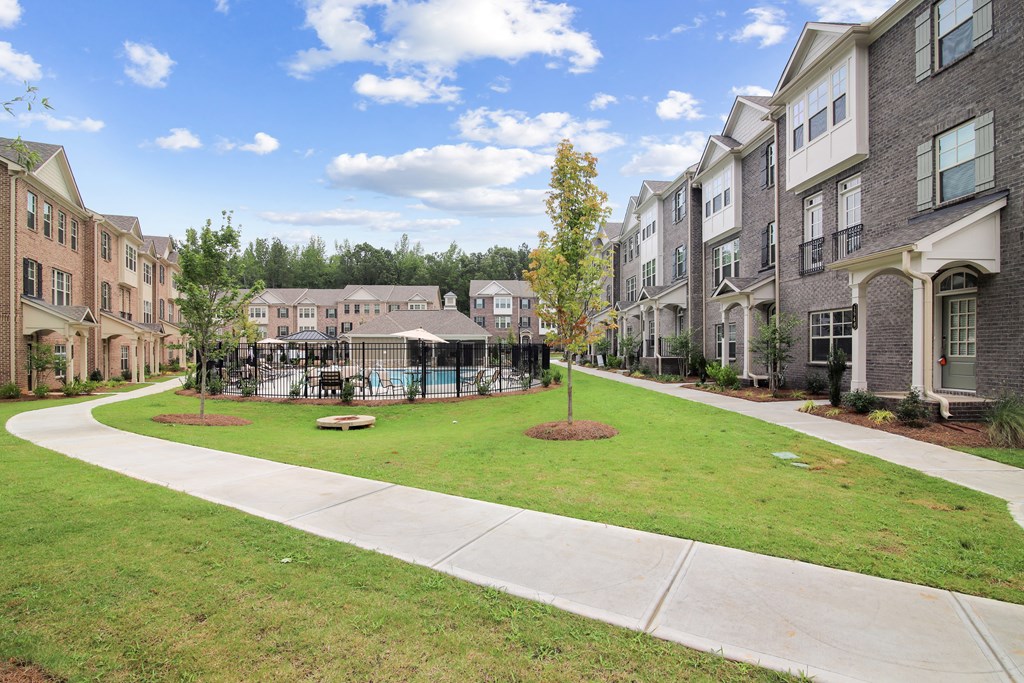 the preserve at ballantyne commons exterior view of apartment buildings and a green lawn