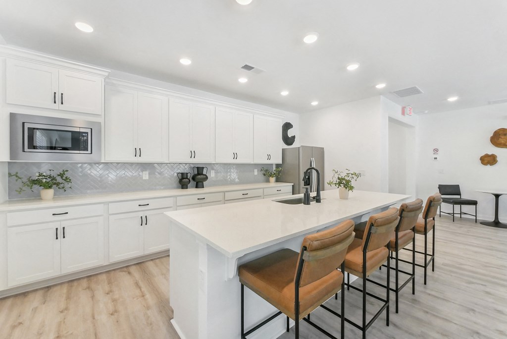 Luxury kitchen featuring white cabinets and breakfast bar