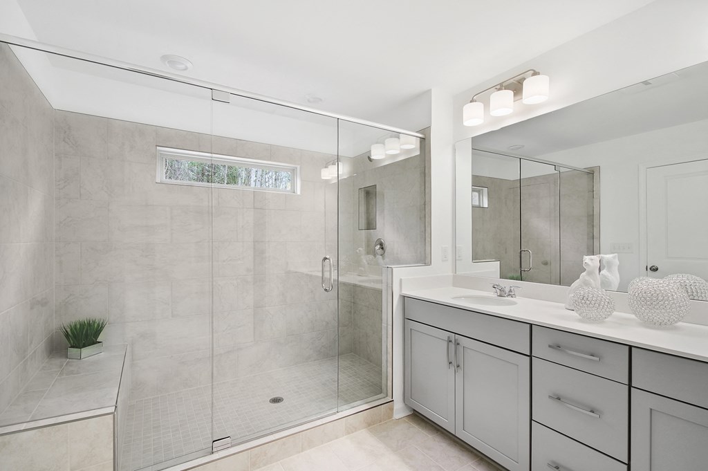 a white bathroom with a shower and a sink