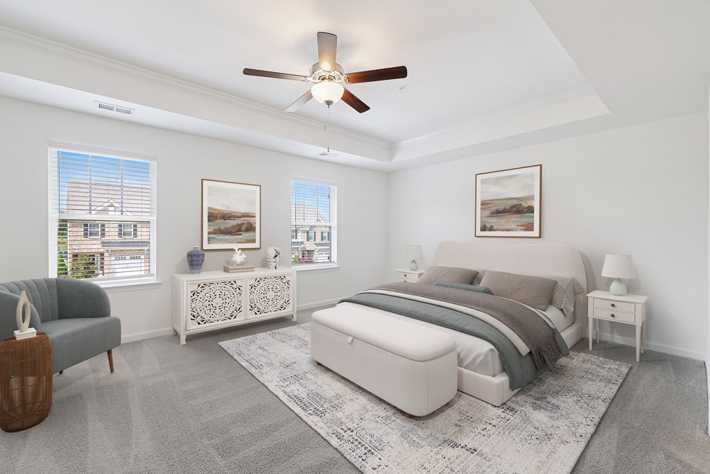 A bedroom with a bed, nightstand, and a sofa.