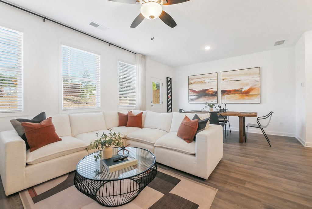 Bright living room with stylish sectional and dining area