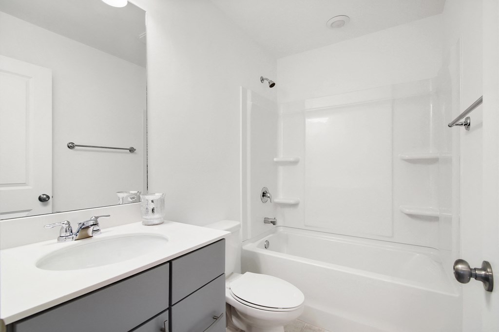 a bathroom with a sink toilet and a bath tub