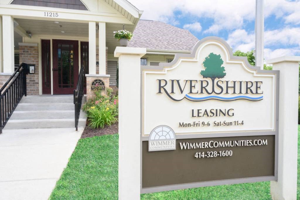 a building with a sign for river shore leasing