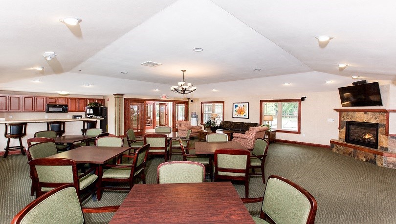 a dining room with tables and chairs and a fireplace