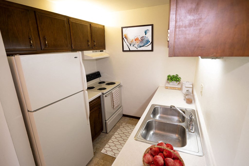 a kitchen with a sink and a refrigerator