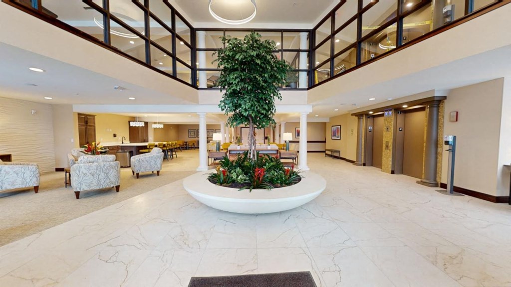 a large lobby with a large tree in the middle of it