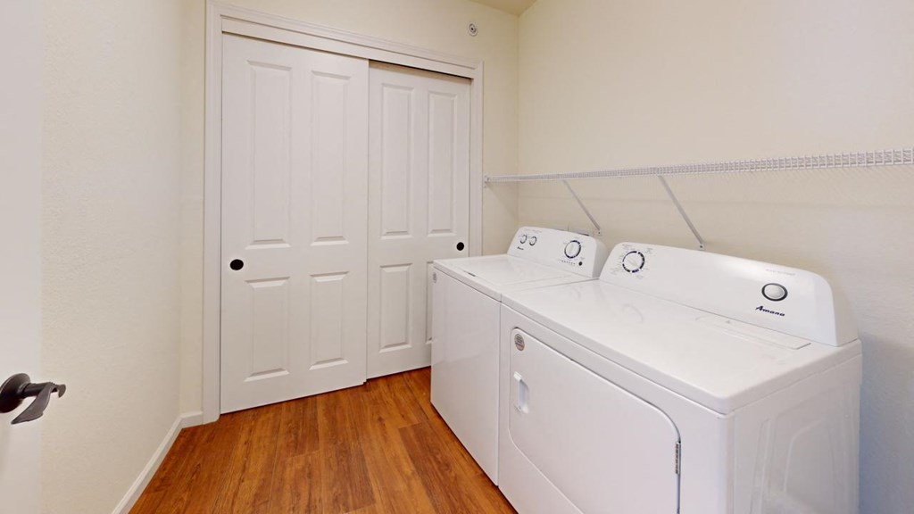 a washer and dryer in a room with a closet