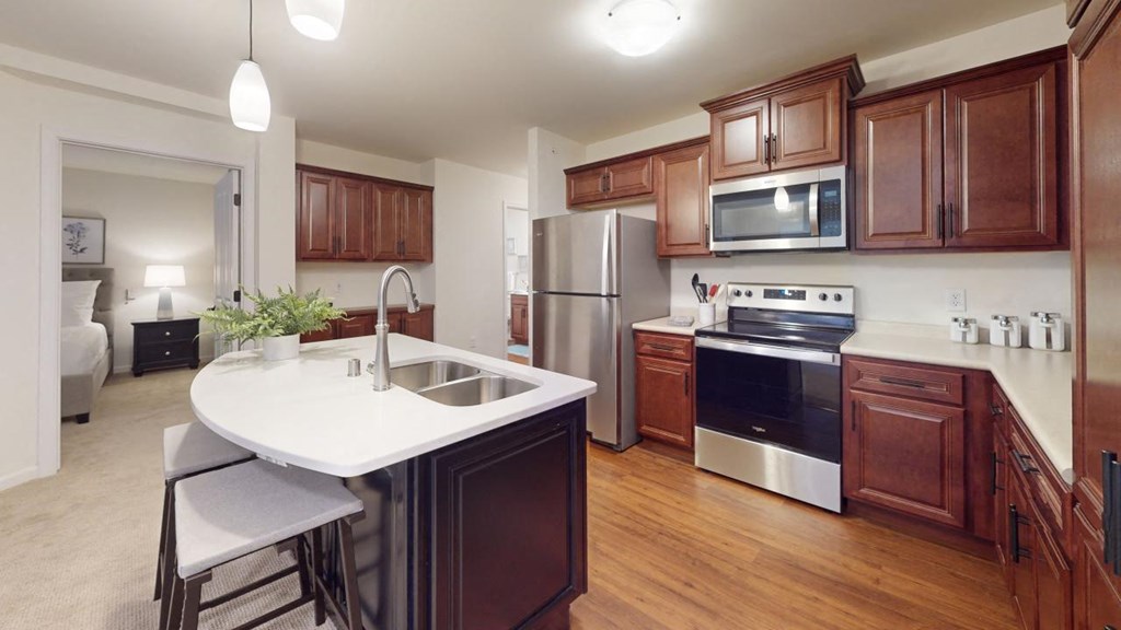 a kitchen with wooden cabinets and stainless steel appliances