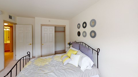 a bedroom with a bed and a door to a bathroom