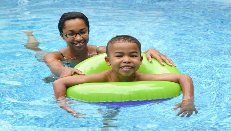 a woman and a boy in a swimming pool
