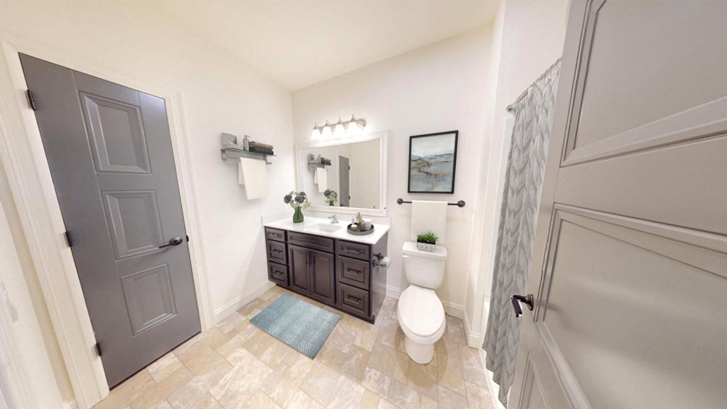 a white bathroom with a toilet and a sink