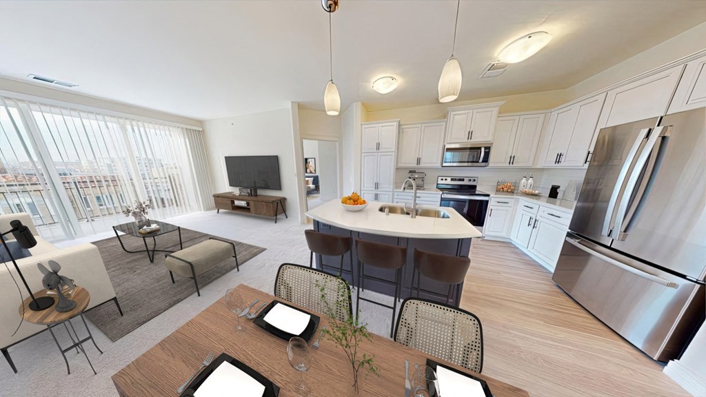 an open kitchen and living room with a table and chairs