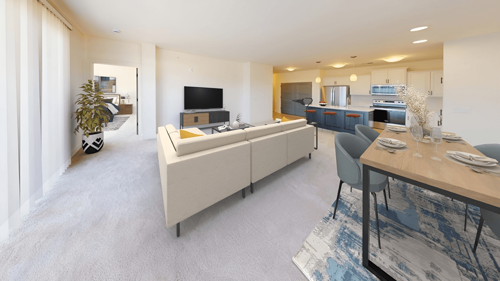 a living room and kitchen with a table and chairs