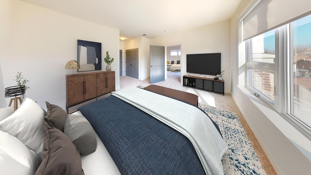 a bedroom with a large bed and a tv in the corner