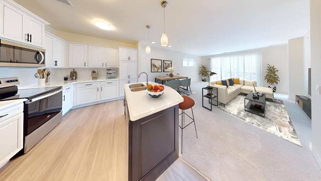 a kitchen and living room with a large counter top