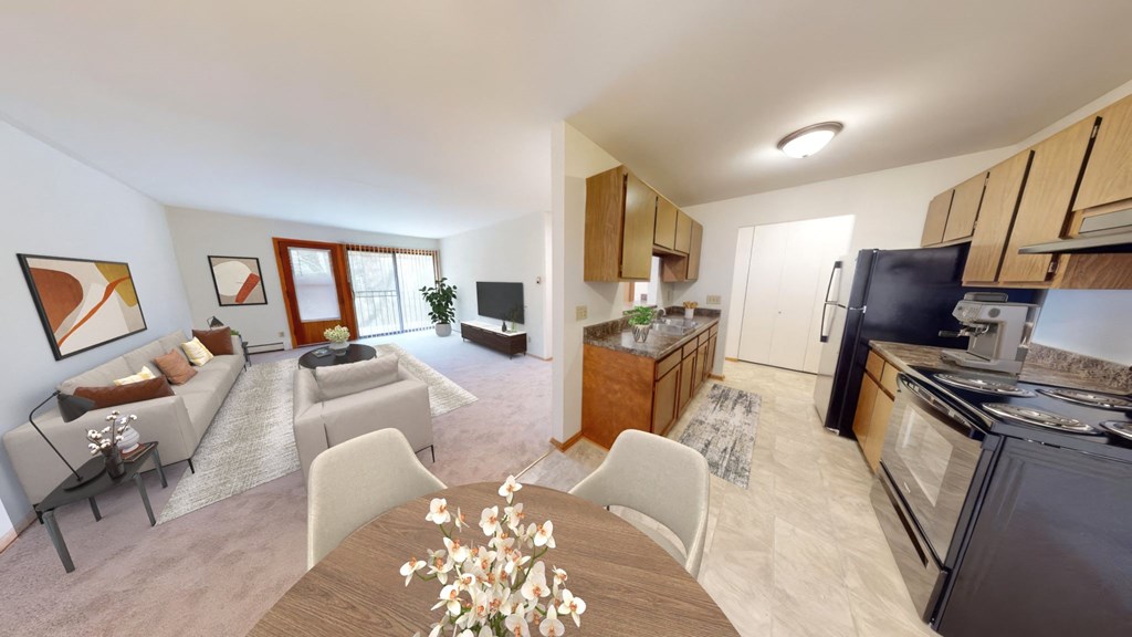 a living room and kitchen with a table and chairs