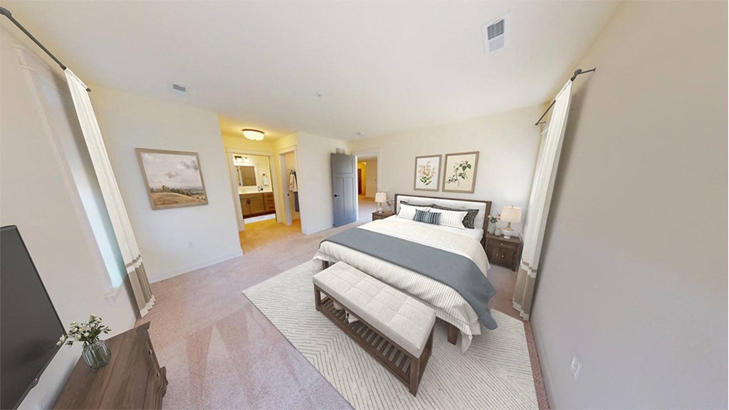 a bedroom with a bed and a bathroom in the corner