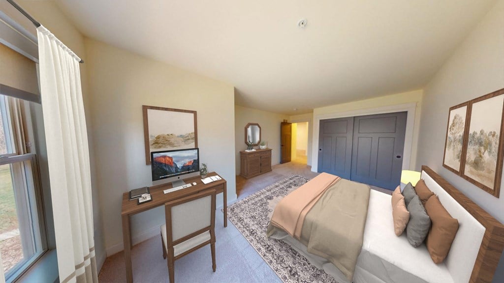 a bedroom with a bed and a desk with a tv