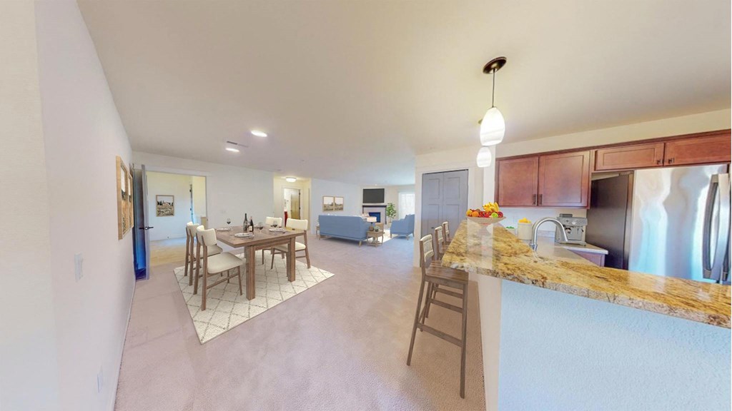 a kitchen with a bar and a dining table