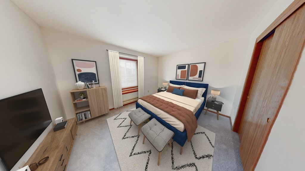 a bedroom with a bed and a tv in the corner of a room