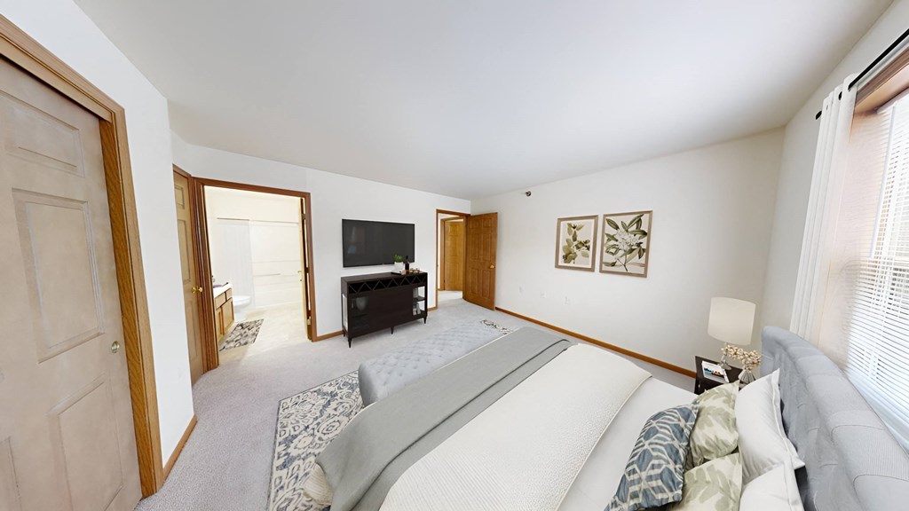 a bedroom with a bed and a tv