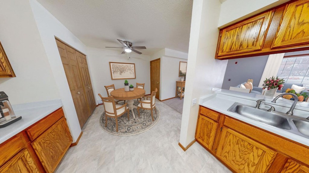 a kitchen and dining room with a table and chairs