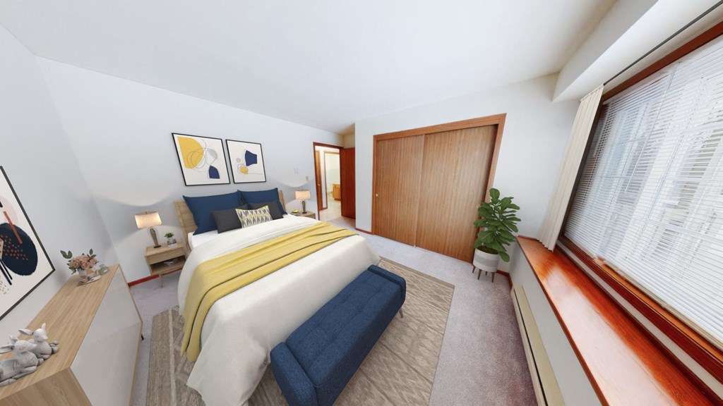 a bedroom with a bed and a window