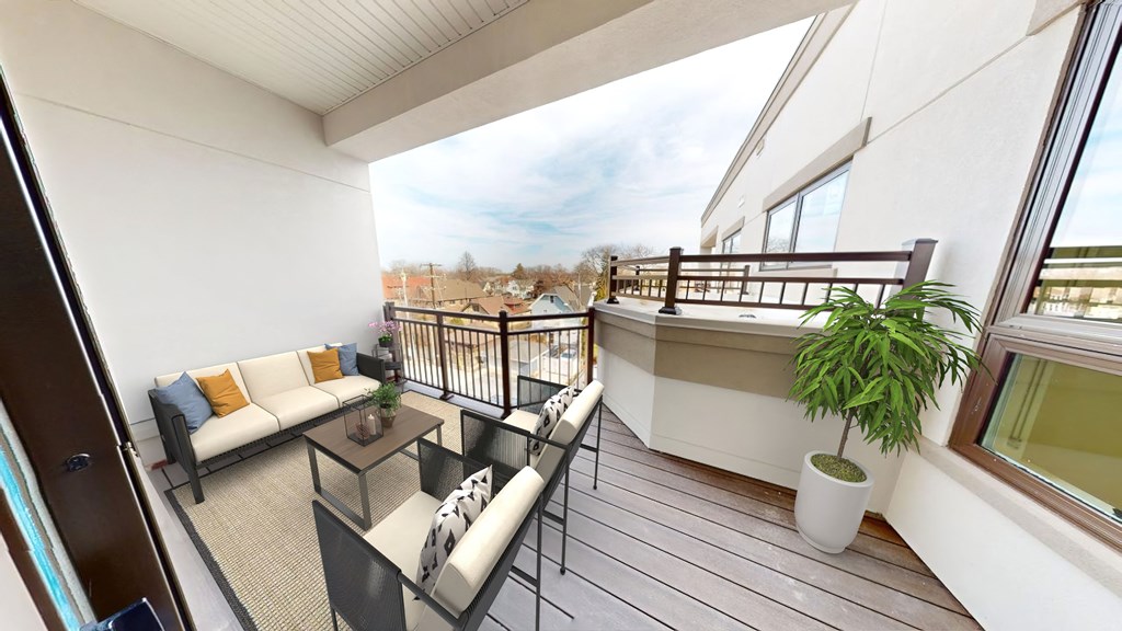 a balcony with a couch and a table