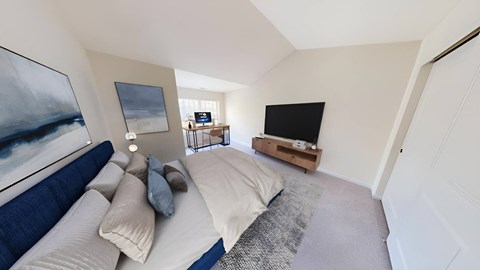 a bedroom with a bed and a tv