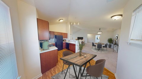 a kitchen and dining room with a table and chairs