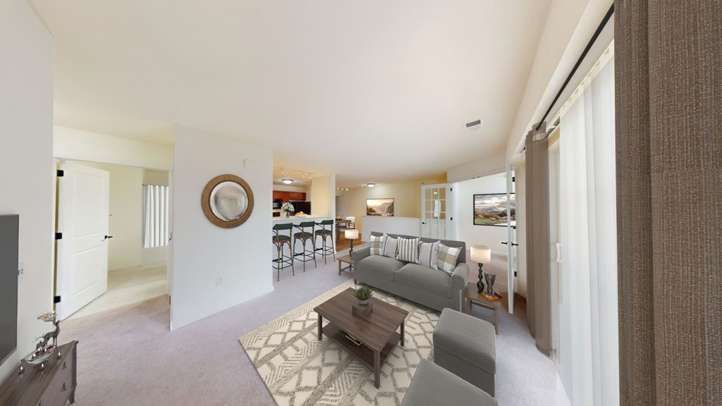 A living room with a grey couch and a coffee table.