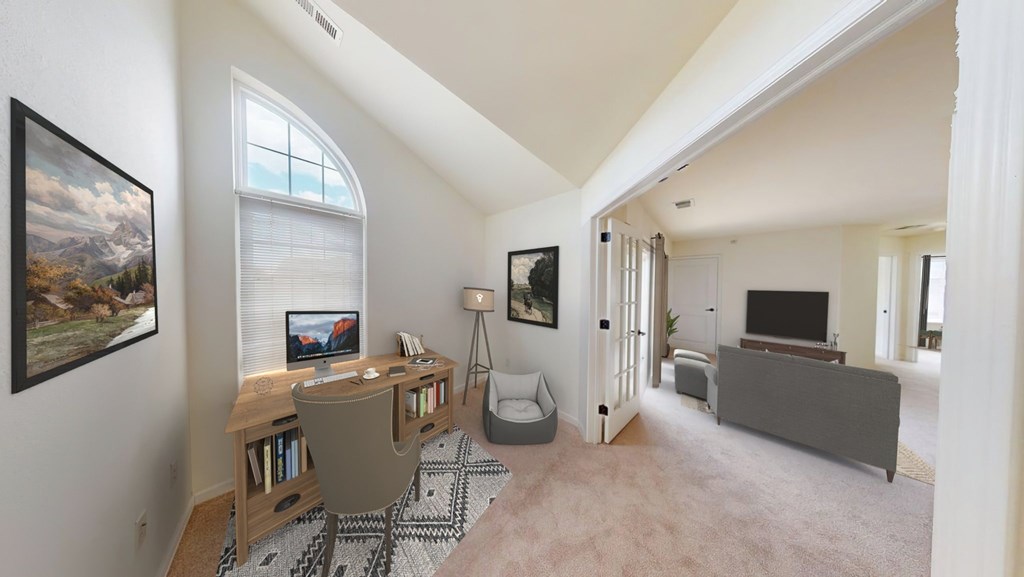 A living room with a television, a chair, and a rug.