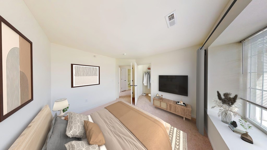 A living room with a couch, a television, and a painting on the wall.