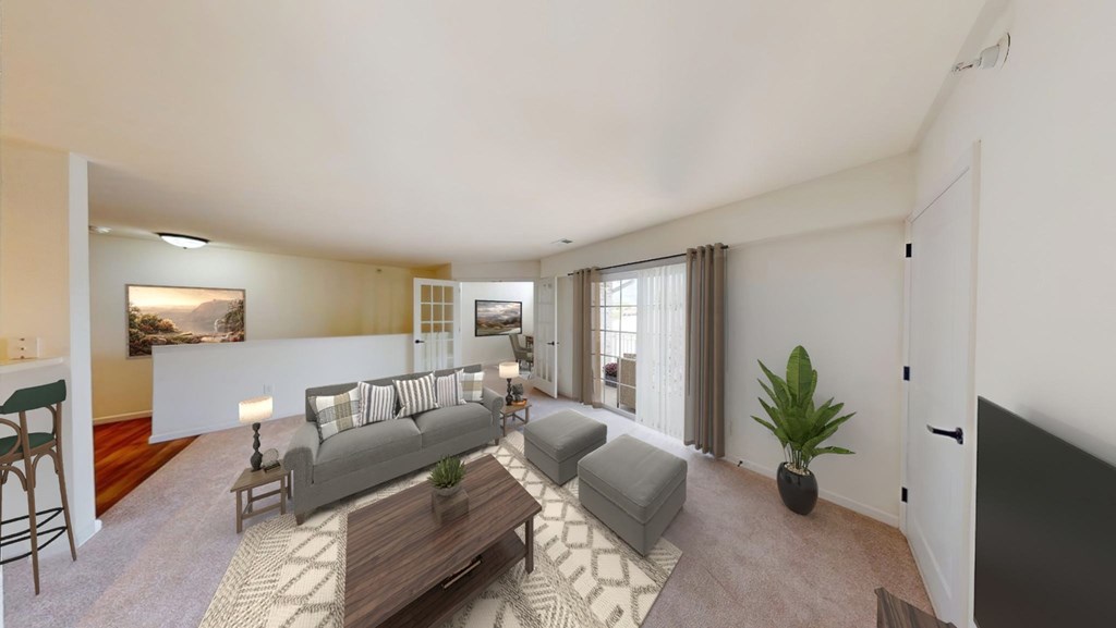 A living room with a grey couch and a wooden coffee table.
