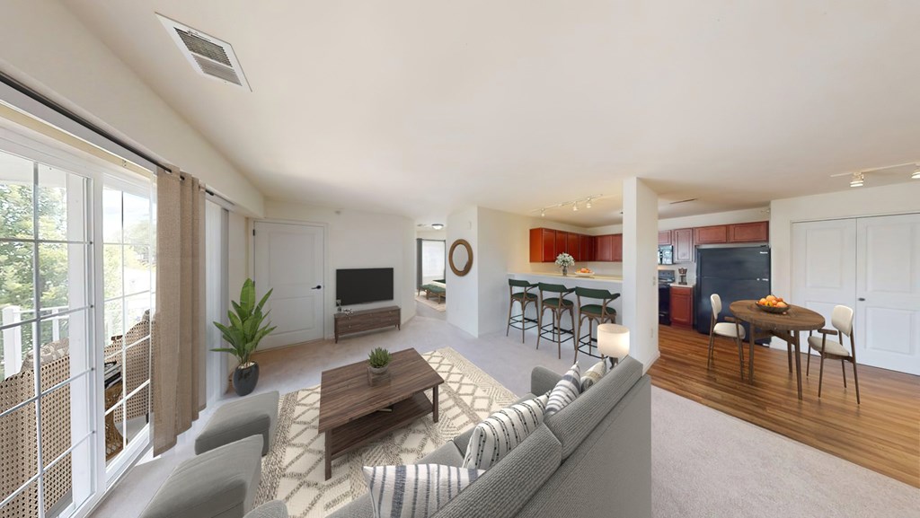 A modern living room with a grey sofa and a wooden coffee table.