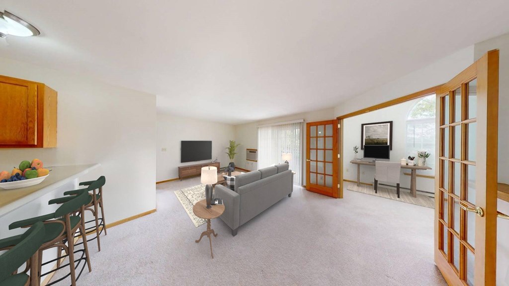 A living room with a grey couch and a television.