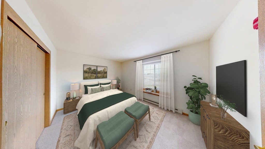 A bedroom with a bed, a bench, a plant, and a television.