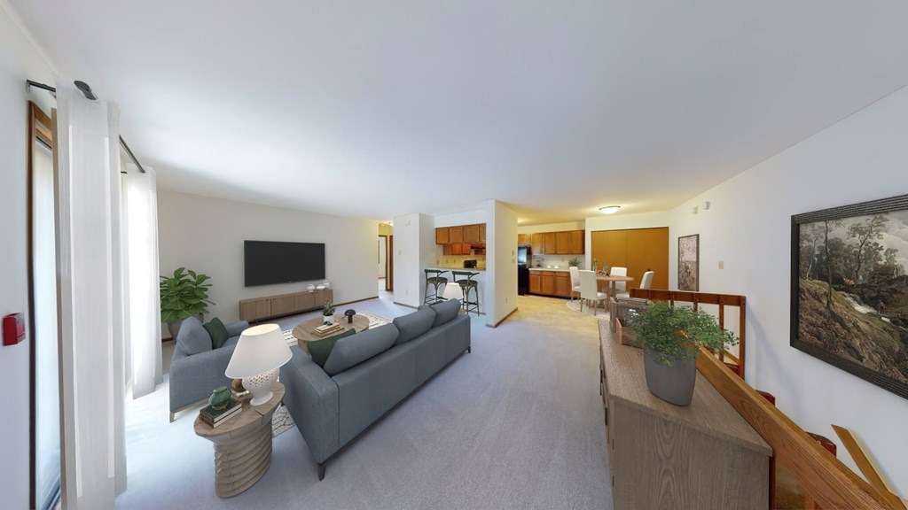 A living room with a grey couch and a wooden table.