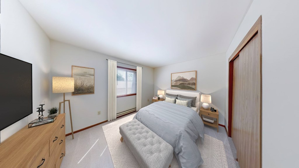 A bedroom with a bed, nightstand, and a television.