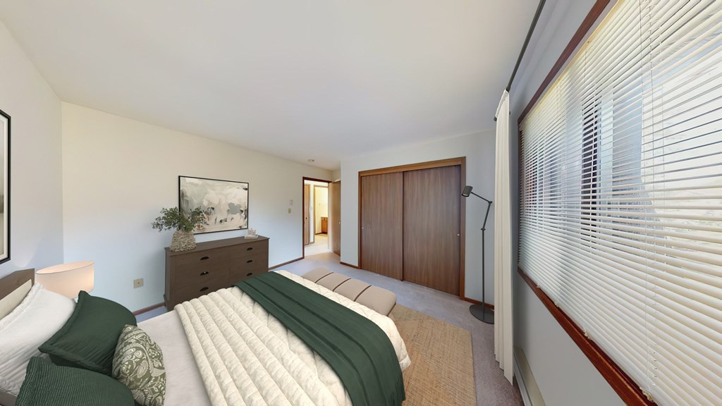 A bedroom with a bed, nightstand, and a painting on the wall.