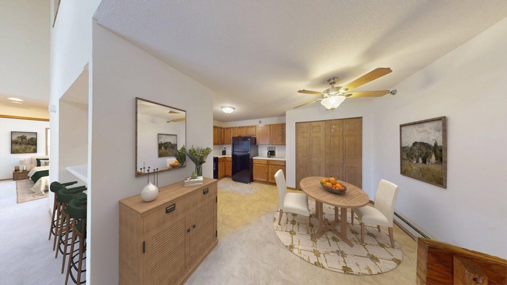 A dining room with a wooden table and chairs.