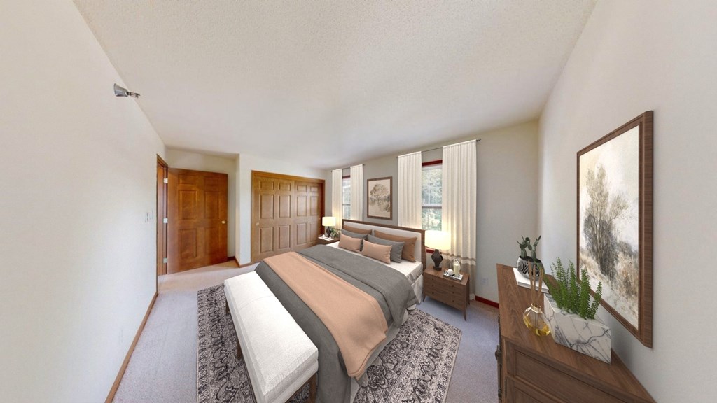 A bedroom with a large bed and a painting on the wall.