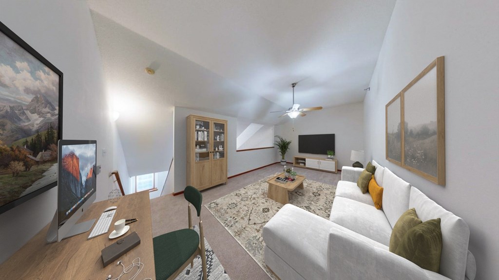 A living room with a white couch and a painting on the wall.