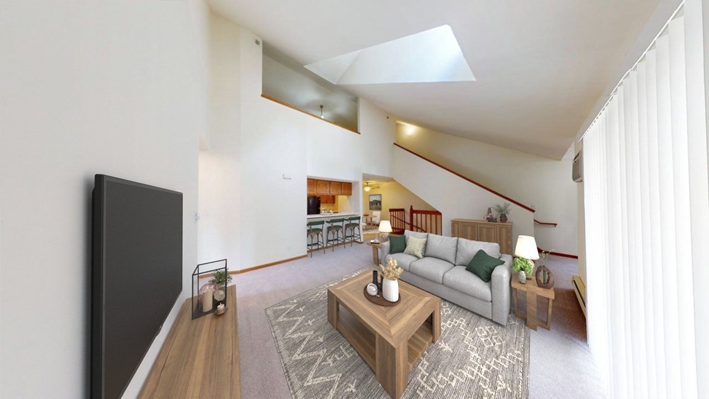 A living room with a grey couch and a wooden coffee table.