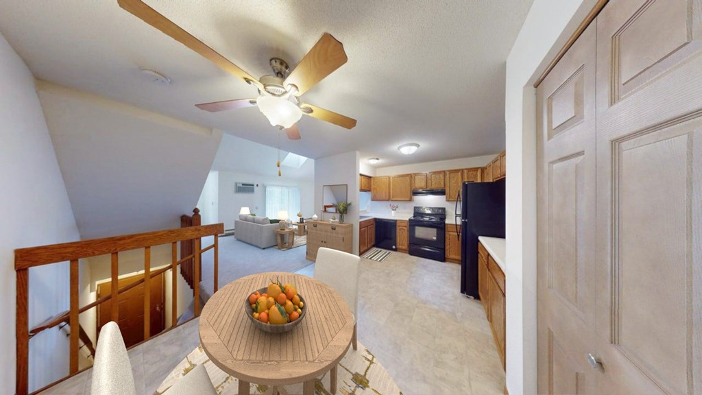 A living room with a dining table and chairs.